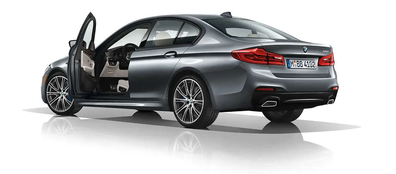 Gray BMW 5 Series sedan with the driver's side door open, showing a tan interior.